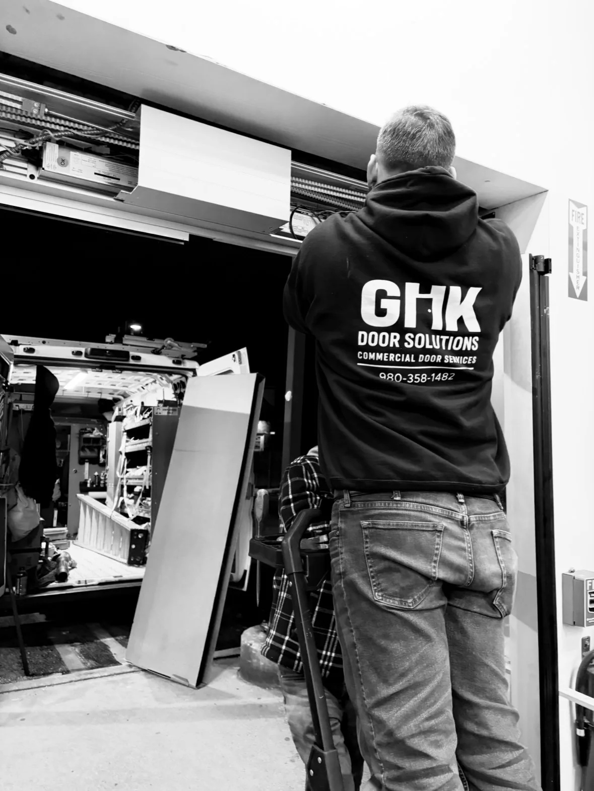GHK technician servicing a commercial door