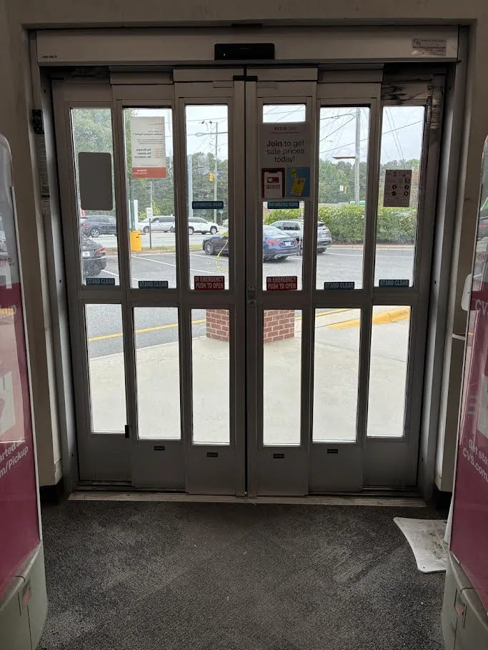 Commercial folding automatic doors installed at a CVS pharmacy entrance