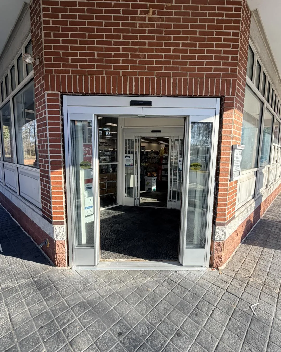 Modern commercial automatic glass entrance at dusk