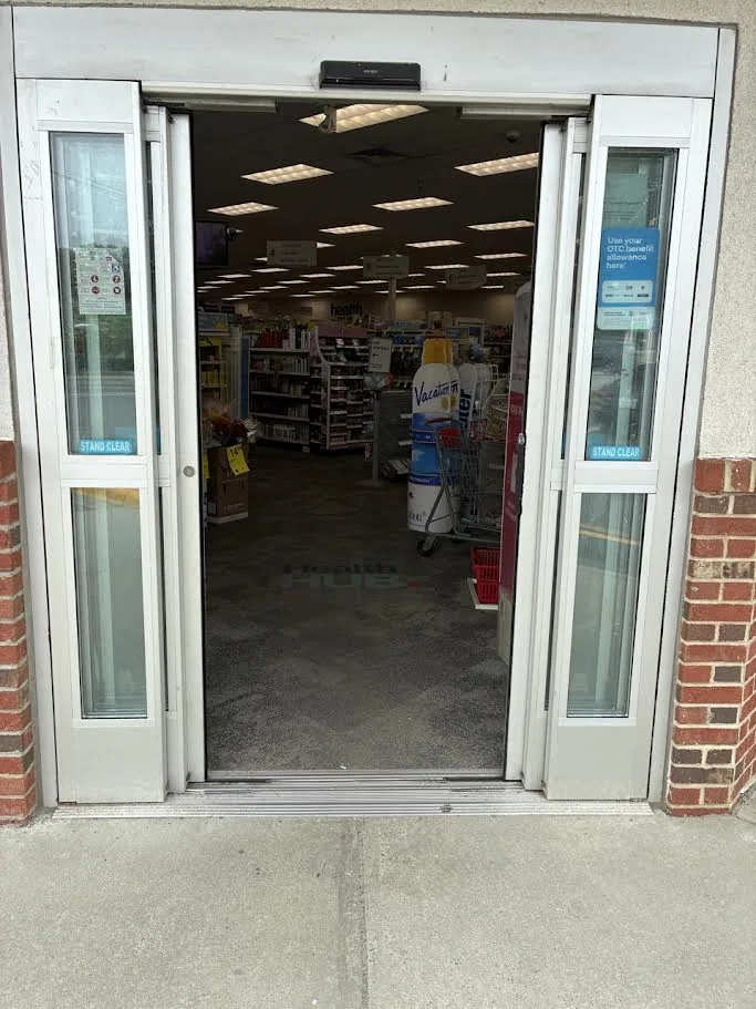 Sliding automatic entrance doors fully open at a retail storefront